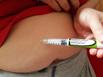person holding green and white syringe thumbnail