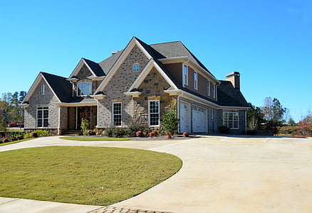 photo of gray house with garage and green grass thumbnail