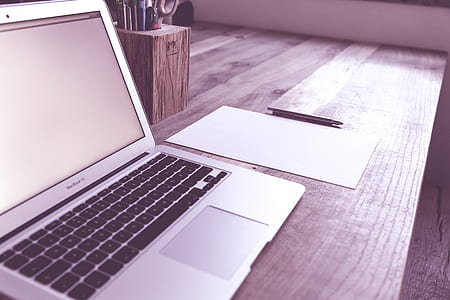 MacBook Air near white blank paper and click pen thumbnail