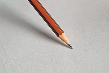 macro photography of brown pencil tip on white surface thumbnail