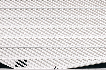 Girl Running Past Modern Architecture Photo thumbnail