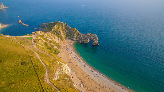 aerial photography of mountain near ocean thumbnail