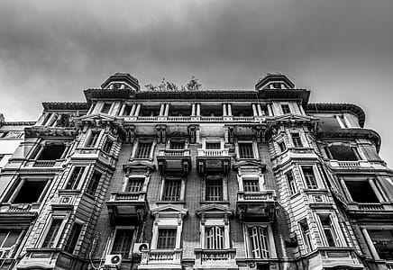 Low-angle and Grayscale Photo of Concrete Building thumbnail