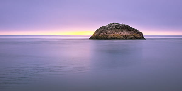 brown and green island on body of water thumbnail