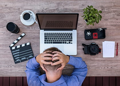 closeup photo of man facing gray laptop on table thumbnail