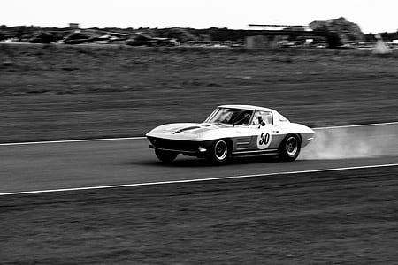 grayscale photography of classic stock car on road thumbnail