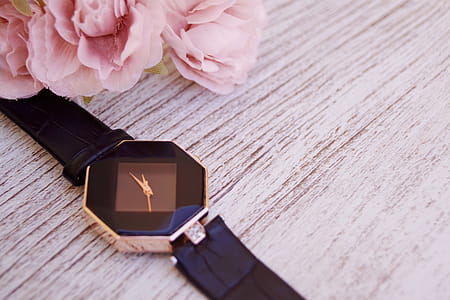 Gold-colored Analog Watch on Beige Wood Surface thumbnail