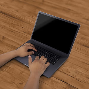 person touches laptop computer thumbnail