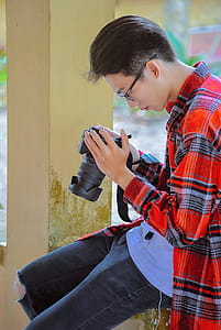 Photography of a Man Holding Black Camera thumbnail