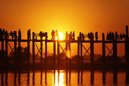 silhouette of people on wooden dock during golden hour thumbnail