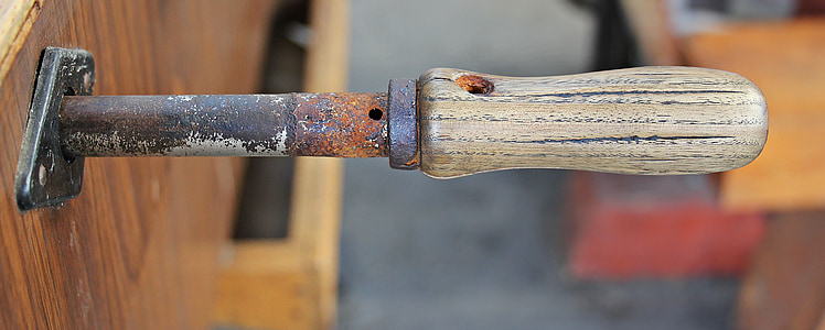 gray handle hand tool on brown wooden surface thumbnail
