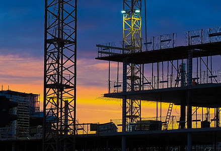 construction cranes during sunset thumbnail