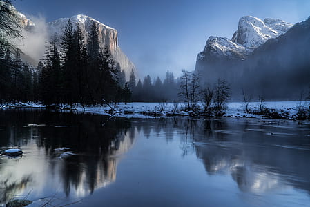 lake with view of snow filled mountain thumbnail