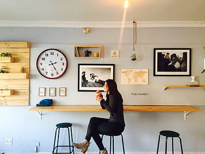 smiling woman sitting on bar stool in dining area thumbnail