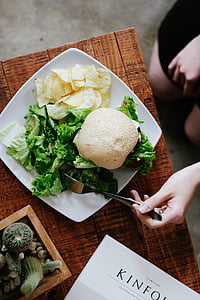 flat lay photography of burger, lettuce and chips on plate thumbnail