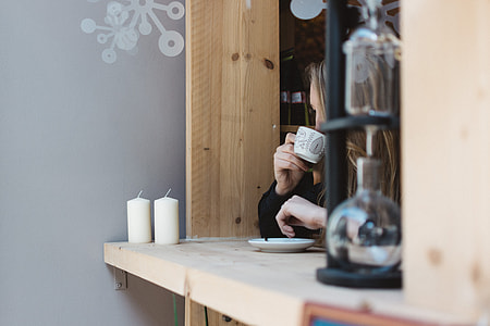 Girl drinking coffee at a window seat thumbnail