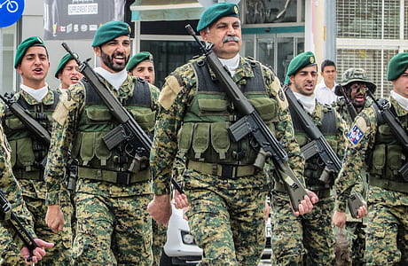 policemen holding rifles during daytime thumbnail