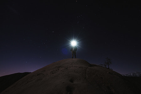 person standing on hill during nighttime thumbnail