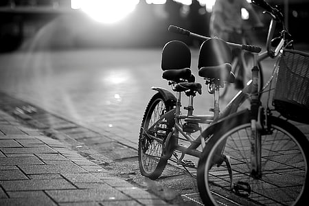 grayscale photography of bicycle parked beside street thumbnail