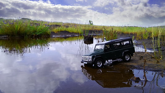 black vehicle beside body of water thumbnail