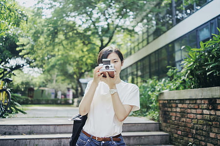 woman taking photo using camera thumbnail