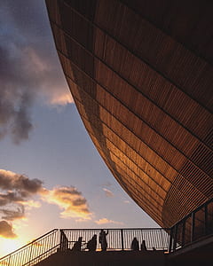 silhouette photography of people walking on stair during golden hour thumbnail