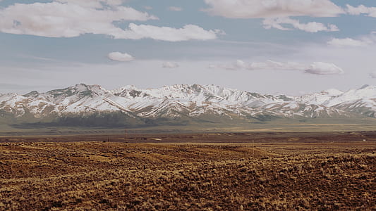 snow capped mountain near brown fiele thumbnail