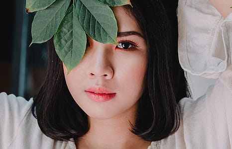 Woman Covering Her Face With Leaves thumbnail