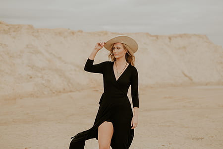 woman standing on dessert during daytime thumbnail