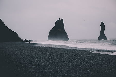 seashore near rock formation at daytime thumbnail