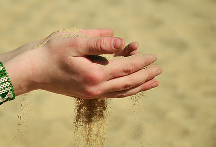 person holding sand thumbnail