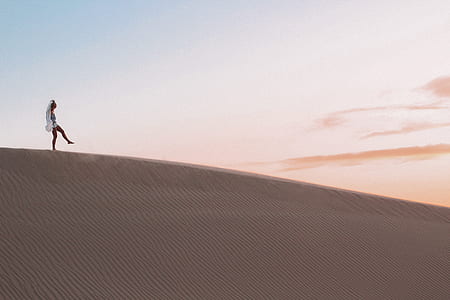 walking person on desert under clear sky thumbnail