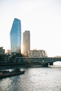 Gray Concrete Buildings Near Bridge and Body of Water thumbnail
