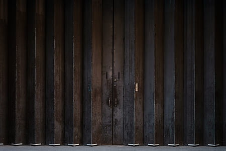 closed brown and black metal door thumbnail