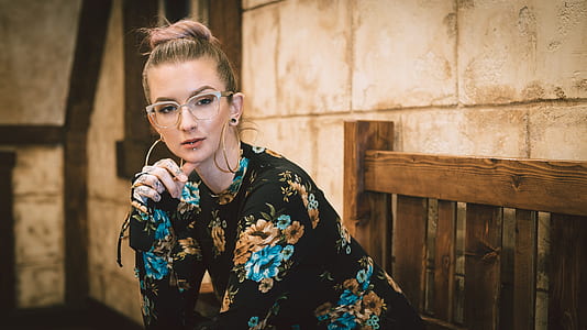 model woman sitting on bench taking photo at daytime thumbnail