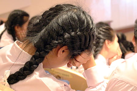 Bored teenage school girl sleeps in class - Editorial use thumbnail