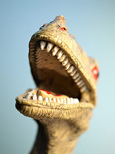 close-up photo of brown dinosaur toy thumbnail