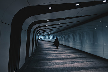 Person walking in modern city tunnel thumbnail