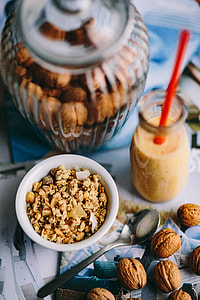 Jar full of walnuts with a fresh healthy shake and musli in a bowl thumbnail