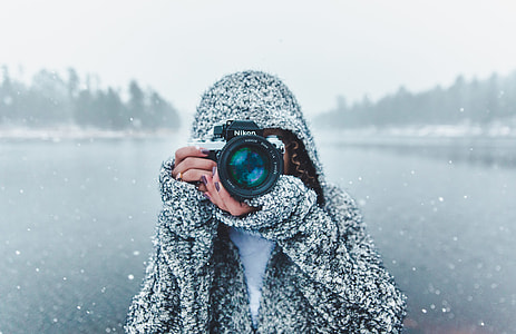 person holding black camera while raining thumbnail