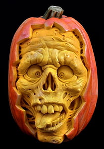 yellow and orange skull inside pumpkin decor thumbnail
