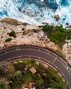 aerial view of road near body of water thumbnail