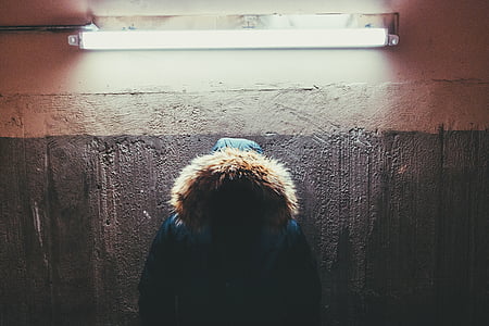 blue and brown coat hanged on wall thumbnail