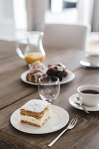 Sweet dessert with cream and a cup of coffee on a table thumbnail