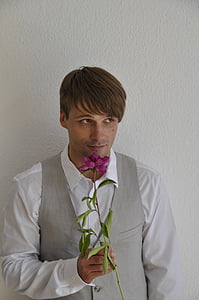 man holding purple flower thumbnail