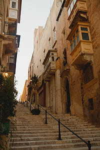 Brown Concrete Buildings With Stairs thumbnail