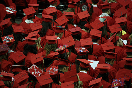 photo of people in red academic dress and caps thumbnail