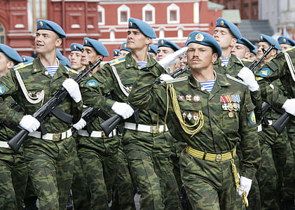 group of men soldiers parade near brown building thumbnail