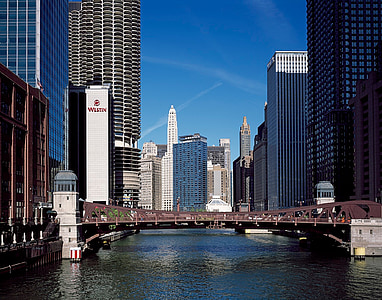 landscape photography of brown and gray bridge near commercial high-rise buildings during daytime thumbnail