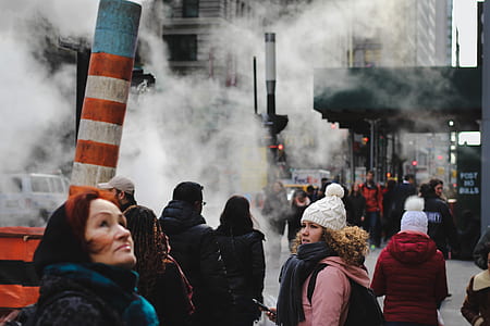 people walking on road covered with smoke thumbnail